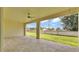 Spacious covered patio with tile flooring and views of the landscaped backyard at 2736 Sunrise Landing Ln, Lakeland, FL 33812