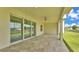 Covered patio with tile flooring, ceiling fan, and sliding glass doors to backyard at 2736 Sunrise Landing Ln, Lakeland, FL 33812