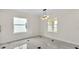 Bright dining area with natural light, featuring tile floors and modern chandelier at 2736 Sunrise Landing Ln, Lakeland, FL 33812