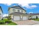 Two-story home with a two-car garage and paver driveway, showcasing curb appeal at 2736 Sunrise Landing Ln, Lakeland, FL 33812