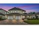Exterior shot of the house at dusk, highlighting the front entrance and landscaping at 2736 Sunrise Landing Ln, Lakeland, FL 33812