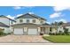 Charming two-story home featuring a three-car garage, a brick-paved driveway, and well-maintained landscaping at 2736 Sunrise Landing Ln, Lakeland, FL 33812
