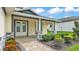 Charming covered front porch with brick accents, stylish double front doors, and manicured landscaping at 2736 Sunrise Landing Ln, Lakeland, FL 33812