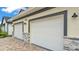 Close-up of the two-car garage featuring stone accents and a paved driveway at 2736 Sunrise Landing Ln, Lakeland, FL 33812