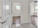 Hallway leading to rooms with tile floors, and doors with stainless steel hardware at 2736 Sunrise Landing Ln, Lakeland, FL 33812