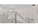 Bright home interior features a glass-lined railing and modern light fixtures at 2736 Sunrise Landing Ln, Lakeland, FL 33812