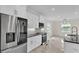 Modern kitchen design with stainless steel appliances, sleek white cabinets, and bright recessed lighting at 2736 Sunrise Landing Ln, Lakeland, FL 33812