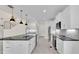 Open-concept kitchen boasts stainless appliances, sleek counters, and modern lighting, perfect for entertaining at 2736 Sunrise Landing Ln, Lakeland, FL 33812