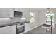 Stylish kitchen with stainless steel oven and microwave complemented by hexagon backsplash and stone countertops at 2736 Sunrise Landing Ln, Lakeland, FL 33812