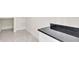 Walk-in pantry featuring sleek countertops, white cabinets, and tiled floors, offering ample storage space at 2736 Sunrise Landing Ln, Lakeland, FL 33812