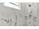 Marble tiled shower features built-in shelving at 2736 Sunrise Landing Ln, Lakeland, FL 33812