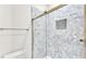 Modern bathroom shower featuring hexagon tile and a glass enclosure at 2736 Sunrise Landing Ln, Lakeland, FL 33812