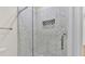 Close-up of a shower with decorative tile, a built-in niche, and glass door at 2736 Sunrise Landing Ln, Lakeland, FL 33812