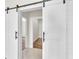 Stylish sliding barn doors offering a glimpse into the home's interior spaces at 2736 Sunrise Landing Ln, Lakeland, FL 33812