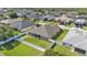 Aerial view of the fenced backyard and exterior featuring a green lawn and surrounding residential neighborhood at 2812 Whitney St, Lakeland, FL 33813