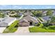 An aerial shot of the home featuring a well-manicured lawn, two car garage, and lovely neighborhood at 2812 Whitney St, Lakeland, FL 33813