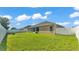 Expansive backyard featuring a lush lawn, white fence, and mature trees for added privacy at 2812 Whitney St, Lakeland, FL 33813