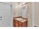Bathroom featuring a vanity with wood cabinetry and a white door leading outside at 2812 Whitney St, Lakeland, FL 33813