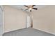 Bedroom featuring neutral walls, gray carpeting, a ceiling fan, and a closet at 2812 Whitney St, Lakeland, FL 33813