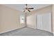 Neutral bedroom with a ceiling fan, plush gray carpeting and a double-door closet at 2812 Whitney St, Lakeland, FL 33813
