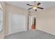 Cozy bedroom showcasing plush carpet, a ceiling fan, and a spacious closet at 2812 Whitney St, Lakeland, FL 33813