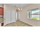 Bright dining area with tile flooring, a modern chandelier, and a view of backyard at 2812 Whitney St, Lakeland, FL 33813