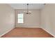 Dining room featuring hardwood floors, a chandelier, and a window that brings in natural light at 2812 Whitney St, Lakeland, FL 33813