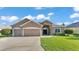 Charming single-story home with a three-car garage and well-manicured landscaping at 2812 Whitney St, Lakeland, FL 33813