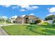Charming single-story home featuring a stone facade, well-manicured lawn, and an attached two-car garage at 2812 Whitney St, Lakeland, FL 33813