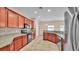 Kitchen showcasing cherry cabinets, granite counters, and stainless appliances at 2812 Whitney St, Lakeland, FL 33813