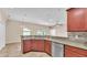 Open kitchen with granite countertops and stainless steel appliances, perfect for entertaining at 2812 Whitney St, Lakeland, FL 33813