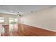 Inviting living room with hardwood floors, ceiling fan, and access to the patio at 2812 Whitney St, Lakeland, FL 33813