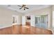 Open main bedroom with hardwood floors, fan and access to bathroom, kitchen and screened in porch at 2812 Whitney St, Lakeland, FL 33813