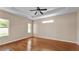 Expansive main bedroom featuring hardwood floors, tray ceiling, and abundant natural light at 2812 Whitney St, Lakeland, FL 33813