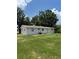 Home's backyard featuring a spacious lawn and a small patio at 29 Coleman Rd, Winter Haven, FL 33880