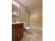 A well lit bathroom featuring a standard shower-tub combo and tiled floors at 29 Coleman Rd, Winter Haven, FL 33880