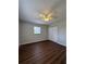 This bedroom boasts hardwood floors, a ceiling fan, and a spacious closet at 29 Coleman Rd, Winter Haven, FL 33880