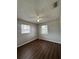 This bedroom offers natural light from two windows and dark hardwood floors at 29 Coleman Rd, Winter Haven, FL 33880