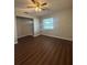 Bedroom featuring modern laminate floors, a ceiling fan, and a bright window at 29 Coleman Rd, Winter Haven, FL 33880