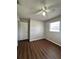 This bedroom offers a window for natural light and dark hardwood floors at 29 Coleman Rd, Winter Haven, FL 33880