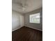 This bedroom boasts hardwood floors, a ceiling fan, and a spacious closet at 29 Coleman Rd, Winter Haven, FL 33880