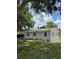 Inviting one-story home featuring a well-manicured lawn and lush landscaping at 29 Coleman Rd, Winter Haven, FL 33880