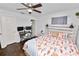 Bedroom with ceiling fan, desk, and a comfortable bed at 3015 Thornhill Rd, Winter Haven, FL 33880