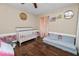 Charming Bedroom with floral accents, featuring a crib and cozy reading nook at 3015 Thornhill Rd, Winter Haven, FL 33880