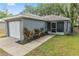 Charming single-story home with a one-car garage and a well-maintained front yard at 3015 Thornhill Rd, Winter Haven, FL 33880