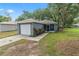 A well-maintained, single-story home featuring a front yard, attached garage, and mature landscaping at 3015 Thornhill Rd, Winter Haven, FL 33880