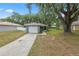 Charming single-story home featuring an attached garage and mature trees providing shade at 3015 Thornhill Rd, Winter Haven, FL 33880