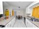 Bright kitchen with white cabinets, stainless steel appliances, and an adjacent dining area at 3015 Thornhill Rd, Winter Haven, FL 33880