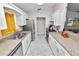 Modern kitchen featuring stainless steel appliances, white cabinetry, and granite countertops at 3015 Thornhill Rd, Winter Haven, FL 33880