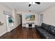 Inviting living room featuring hardwood floors, a comfortable couch, and a mounted television at 3015 Thornhill Rd, Winter Haven, FL 33880